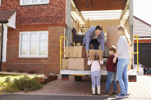 Student moving boxes into storage in Hounslow