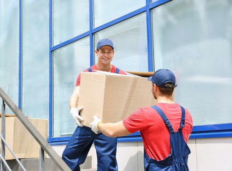 Packed household boxes and furniture ready for transport in Hounslow